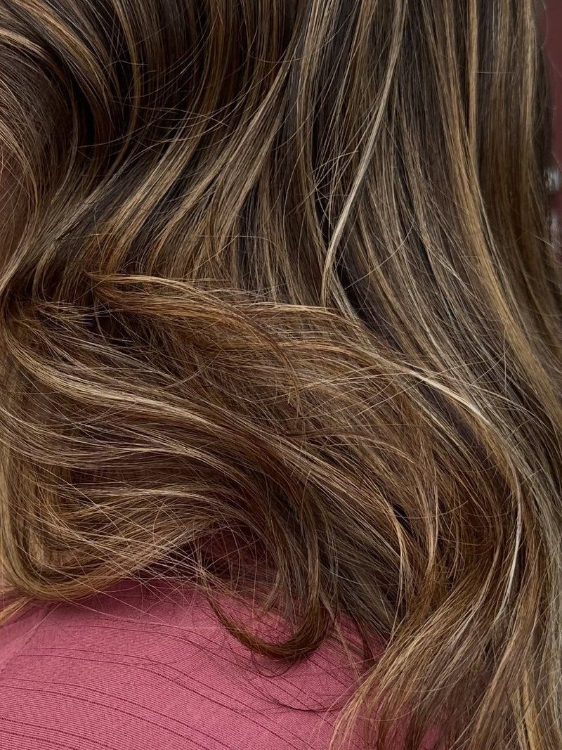 Close up of wavy brown hair with balayage highlights