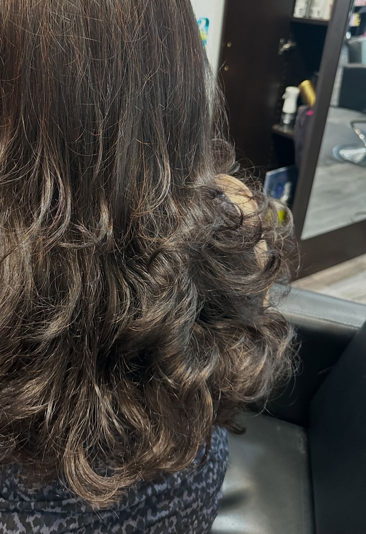 Soft layered cut with loose curls, seen from behind